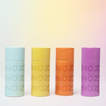 Load image into Gallery viewer, Four Nöz Sunscreen bottles (blue, yellow, orange, and purple) are standing.
